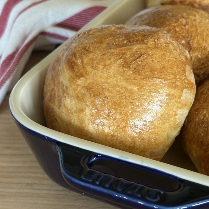 sourdough burger buns in dish with towel