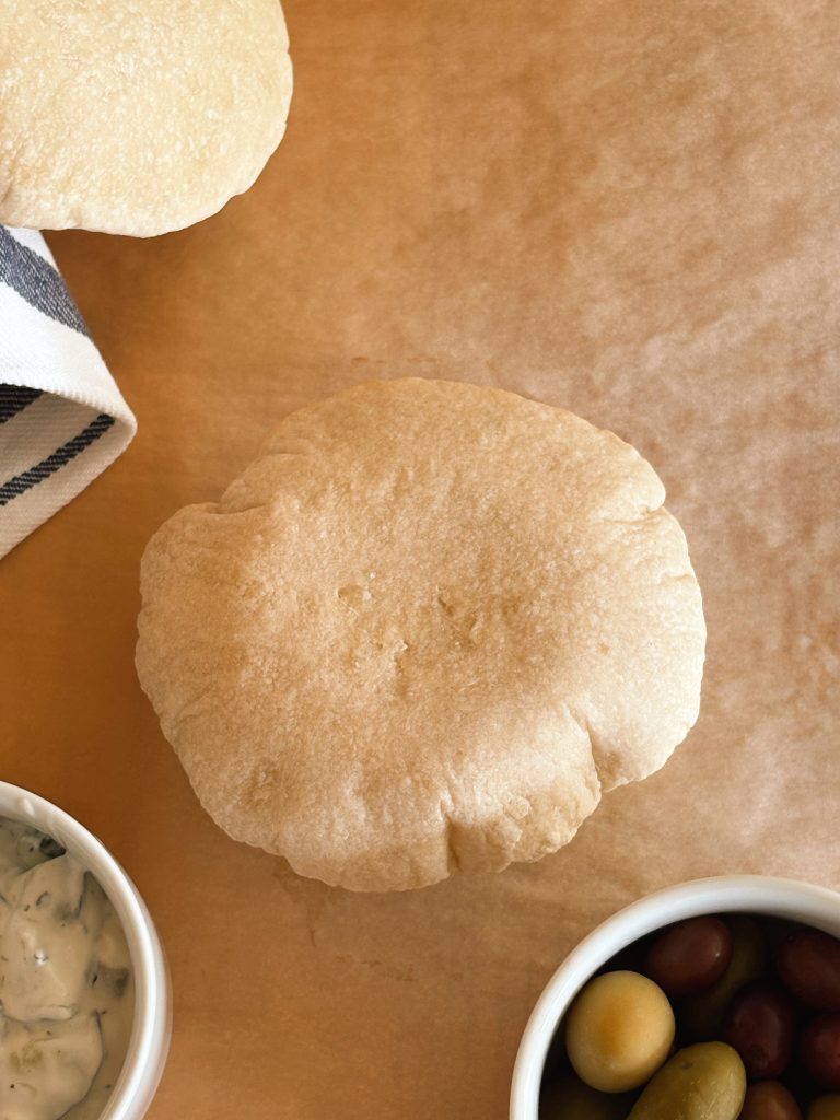 sourdough pita bread with olives and tzatziki