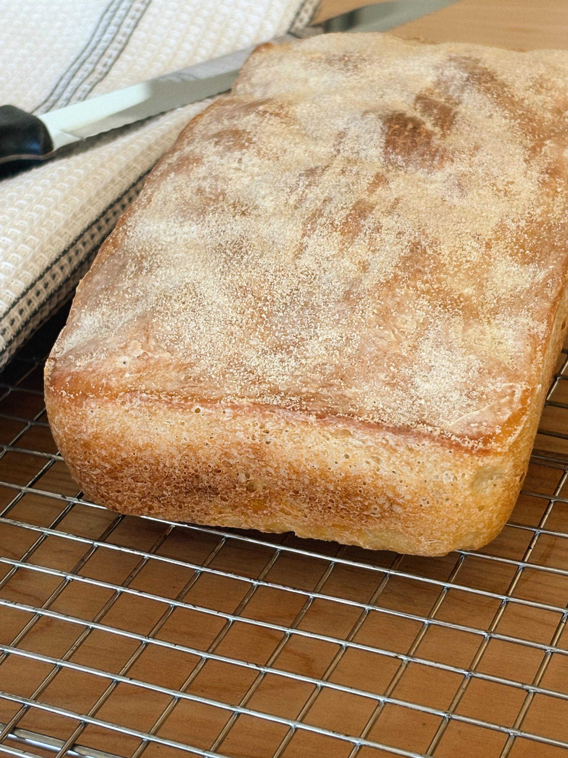 loaf of sourdough english muffin bread with towel