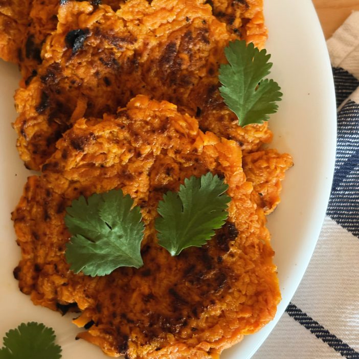 sweet potato latkes on plate with parsley