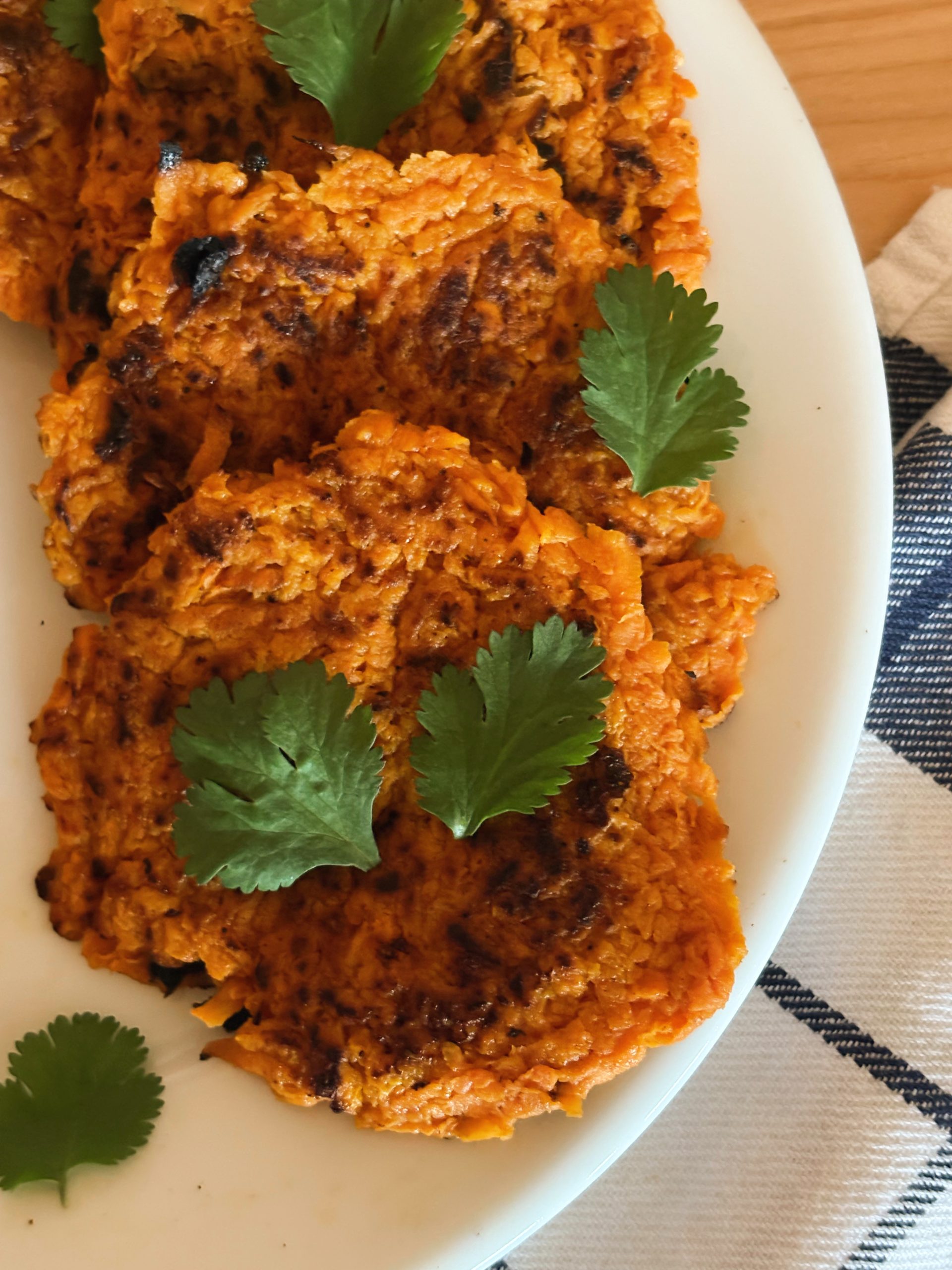 sweet potato latkes on plate with parsley