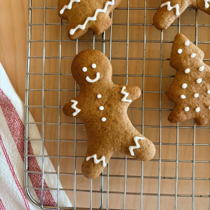 sourdough gingerbread cookies on baking rack with striped towel
