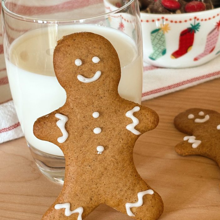 sourdough gingerbread man next to glass of milk with candy