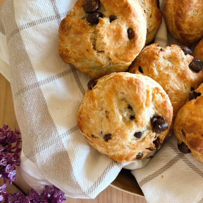 Sourdough chocolate chip scones in basket with lilacs