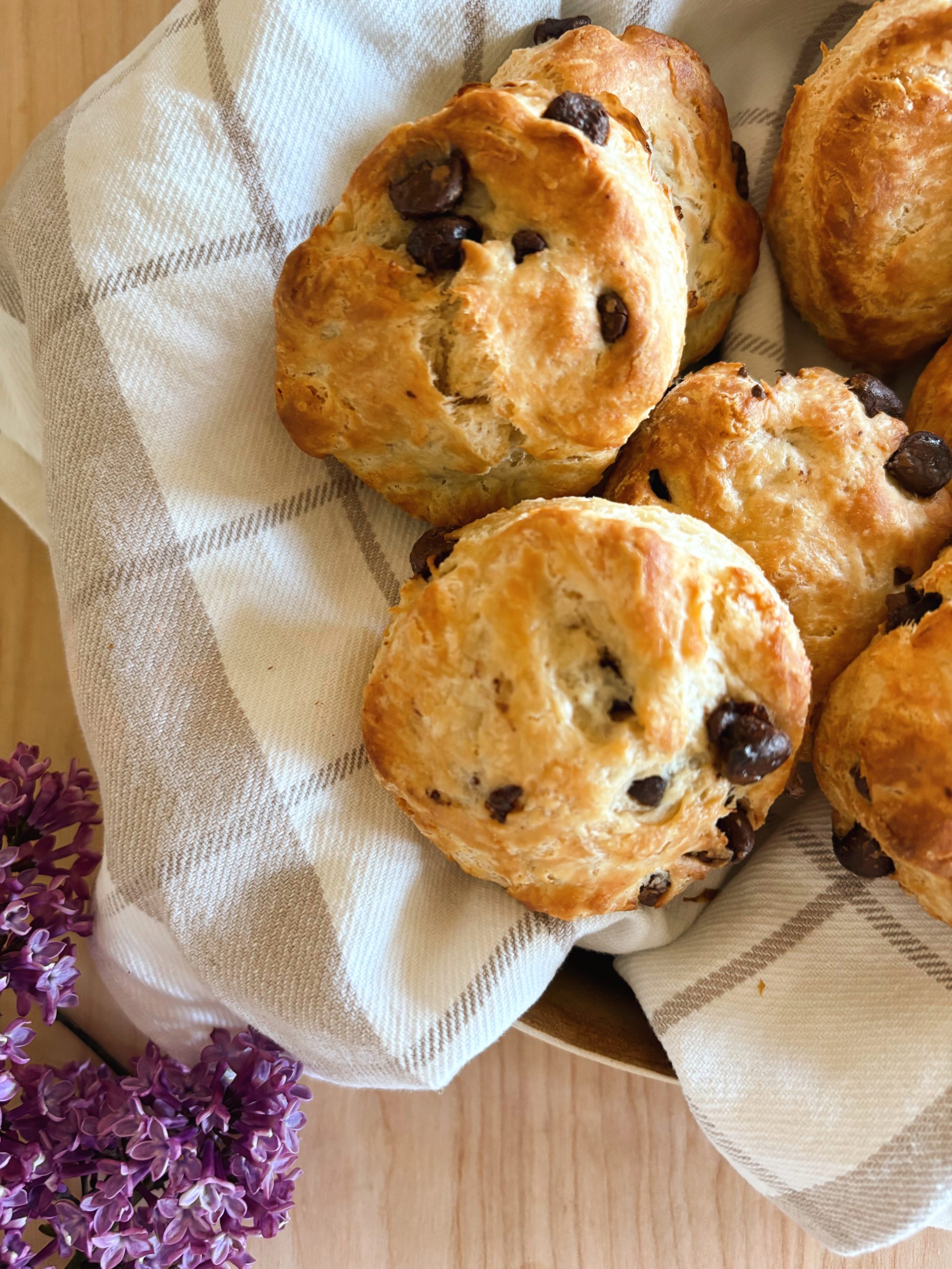 Sourdough chocolate chip scones in basket with lilacs