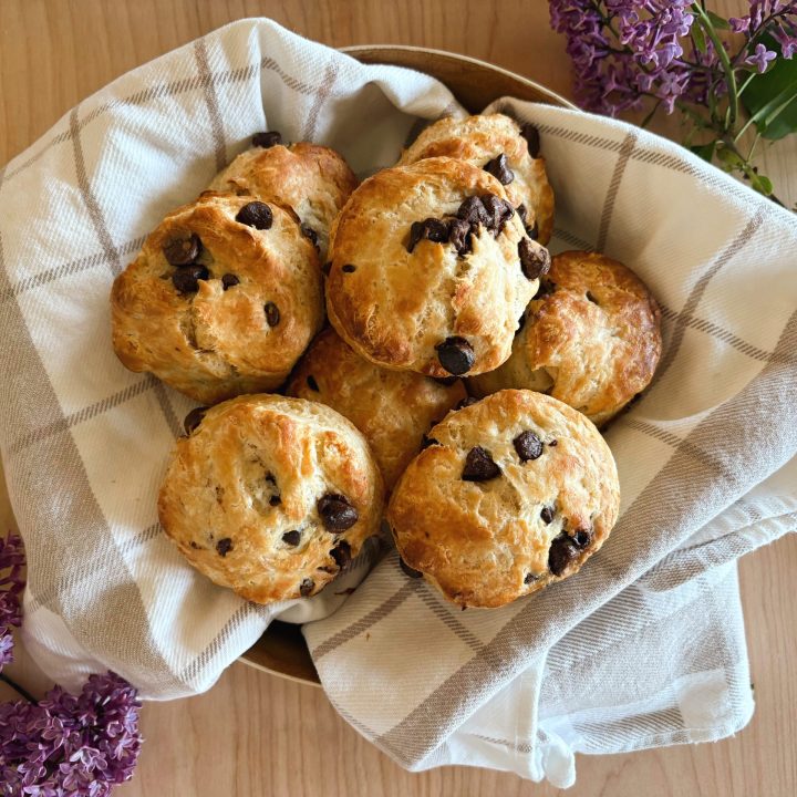 sourdough chocolate chip scones in basket with lilacs